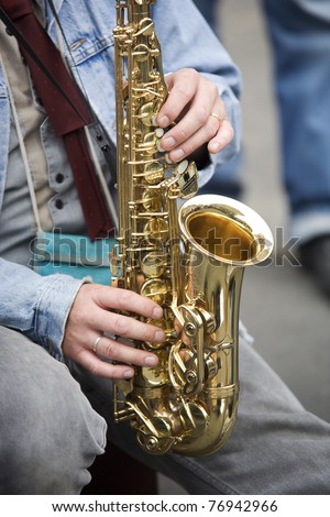 Street performer is playing a sax in Bern, Switzerland.