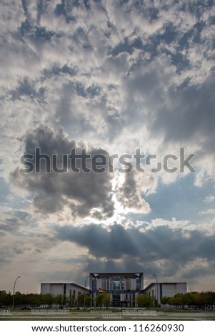 BERLIN, GERMAN, MAY 8: Sun rays of the evening sun come through big gray clouds and hit the building of the offices of the german chancellor \