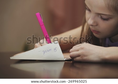 A girl writes a letter to the desire
