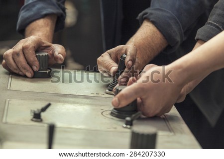 The hands of the two working switch levers and knobs on the old machine