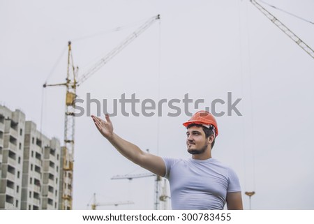 Man the Builder working foreman in the helmet to ensure safety on the construction site. Worker, engineer, foreman, architect.