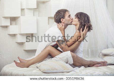 Couple man and woman lay cuddling on the bed at home. Love in family relationships