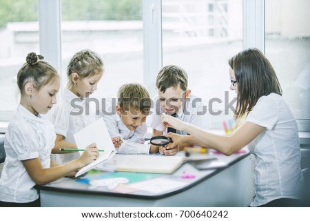 Beautiful children are students together in a classroom in school get the education with the teacher