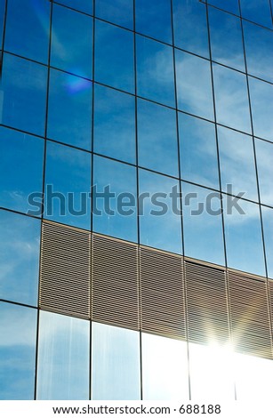 reflection of sky in office block window