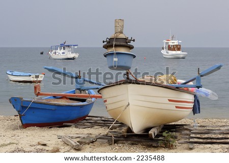 greek fishing boats anchored off the beach