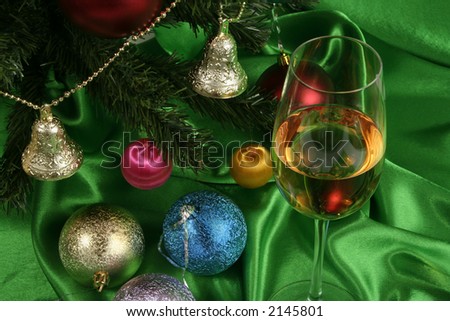 Glass of white wine on a beautiful christmas background with a New Year tree