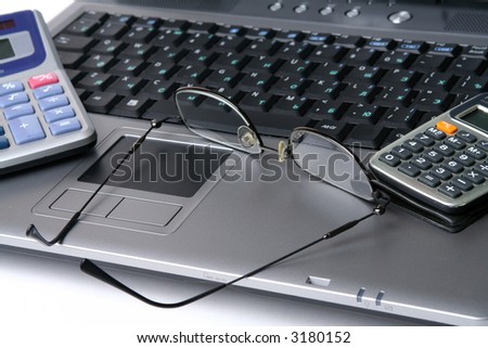 Computer keyboard glasses  calculator on a white background