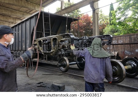 Anhui, Huaibei, China, May 18, 2015. Railway workers assemble railway wagons.