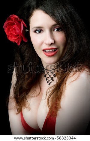 stock photo sexy busty woman wearing rose in hair and low cut red dress