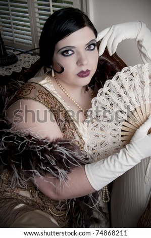 Beautiful woman in retro styled clothes and feather boa