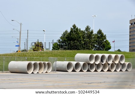 concrete sewage pipes stacked and ready for installation