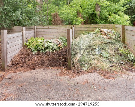 wooden compost bins in garden setting