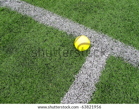 Softball and white corner marking on astroturf field