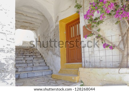 picturesque alley and  bougainvillea flower in a Mediterranean island