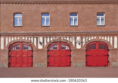 three red doors and four windows, fire squad station, central Europe