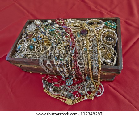 vintage box full of shiny jewelry