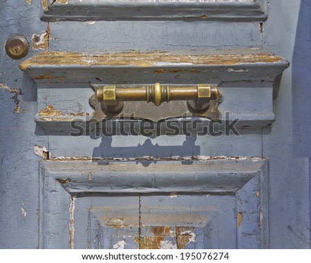 house entrance, old worn door and bronze handle detail