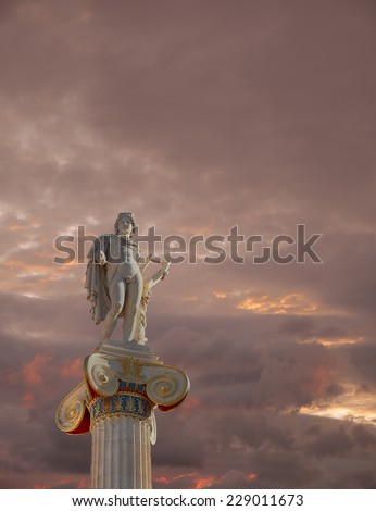 fiery cloudy sky over Apollo statue, the god of poetry and music