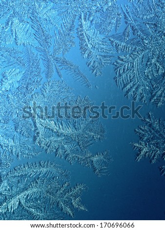 Blue ice crystals on the glass (frosted glass)