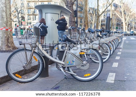 PARIS, FRANCE - JANUARY 6, 2012: Velib bicycles in a row on January 6, 2012 in Paris, France. Velib is a large-scale public bicycle sharing system in Paris, France.