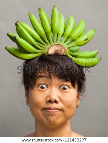 Happy and healthy woman with banana crown on her head