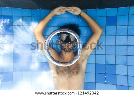Man making bubble rings underwater in pool