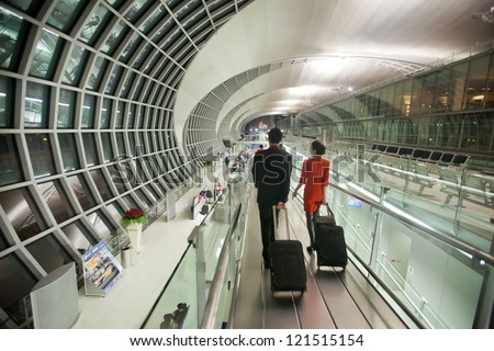 BANGKOK - JANUARY 17. Flight attendants entering departure terminal of Bangkok airport on January 17, 2012. Suvarnabhumi airport is world\'s 4th largest single-building airport terminal.