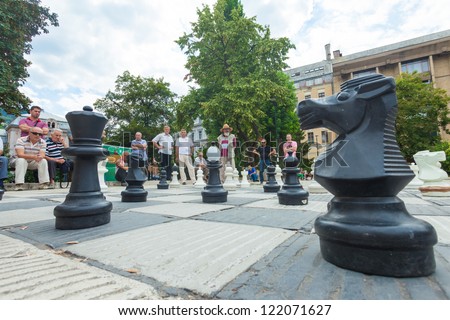 SARAJEVO, BOSNIA - AUGUST 11, 2012: People play outdoor chess game on August 11, 2012 in Sarajevo, Bosnia. Street chess is  a traditional leisurely activity for old Sarajevan men.