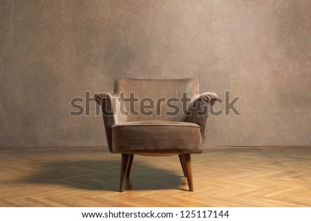 Old chair in grunge room with sepia colour wall