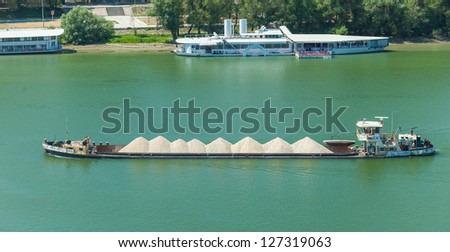 BELGRADE, SERBIA - AUGUST 15: Barge transporting sand on Sava river on August 15, 2012 in Belgrade, Serbia. The Sava is a 990 km long river that discharges into the Danube river in Belgrade.