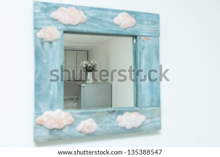 Mirror with blue wooden frame in home interior