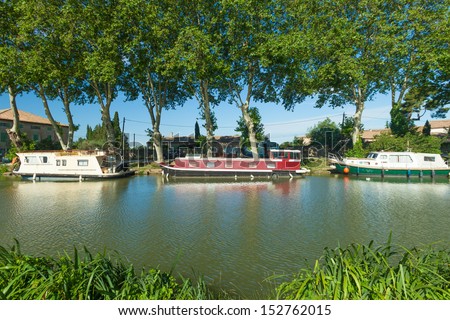 CANAL DU MIDI, FRANCE - JUNE 22: Boats moored in summer on June 22, 2013 on the Canal du Midi, France. The UNESCO listed canal was built in 17th century stretching from Toulouse to Bezier.