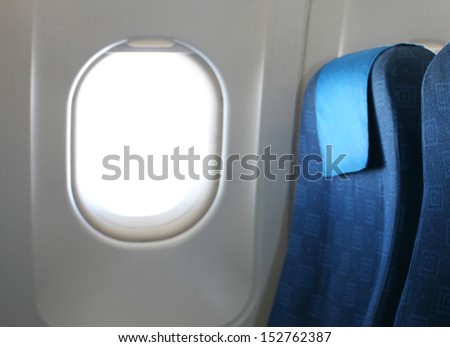 Airplane seat and window inside an aircraft