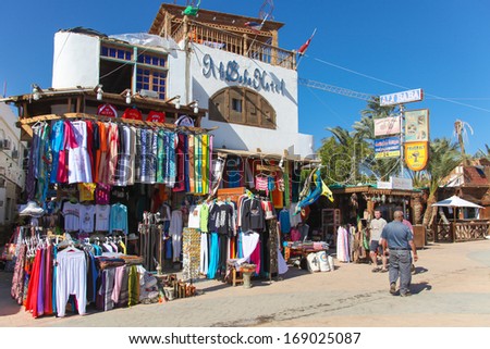 DAHAB, EGYPT - JANUARY 24, 2011: Tourists walk in front of shops on the street on January 24, 2011 in Dahab, Egypt. Dahab has many shops on the street because of the tourists who come there.