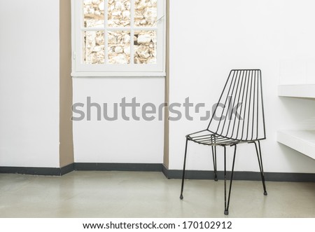 Chair Made Of Wires In The Empty Room With White Walls.