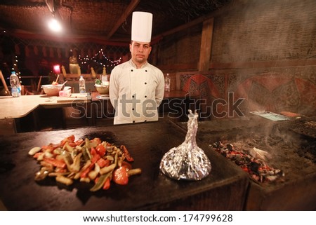DAHAB, EGYPT - JANUARY 28, 2011: Egyptian cook stands in the kitchen. Egyptian food is a mixture of all the different civilisations that came to Egypt in the history of its existence.