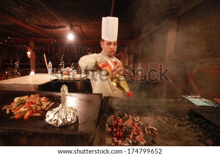 Dahab, Egypt - January 28, 2011: Egyptian Cook Prepares Traditional Meal. Egyptian Food Is A Mixture Of All The Different Civilisations That Came To Egypt In The History Of Its Existence.