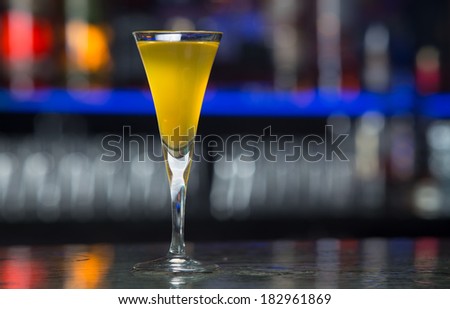 Glass of digestive yellow honey liquor in bar interior