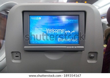 DOHA, QATAR - FEBRUARY 18, 2014: Economy class seat with entertainment system onboard. Qatar Airways Economy Class was named best in the world in the 2009 and 2010 Skytrax Awards.