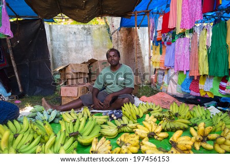 HIKKADUWA, SRI LANKA - FEBRUARY 23, 2014: Local street vendor selling bananas. The Sunday market is a fantastic way to see Hikkaduwa\'s local life come alive along with fresh produce and local delicacy