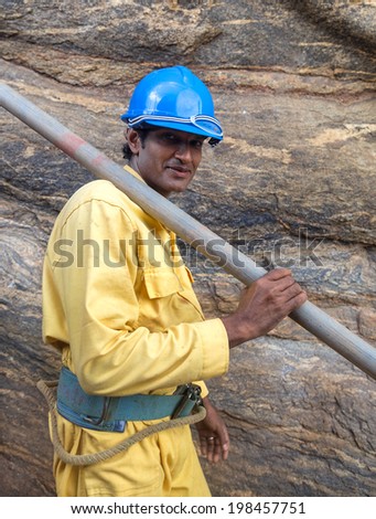 SIGIRIYA, SRI LANKA - 28 FEBRUARY, 2014: Local construction worker in Sigiriya garden complex, UNESCO listed World Heritage Site.