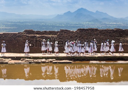 SIGIRIYA, SRI LANKA - 28 FEBRUARY, 2014: Group of school students visiting Sigiriya complex, UNESCO listed World Heritage Site.