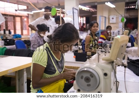 COLOMBO, SRI LANKA - MARCH 12, 2014: Local women working on sewing machine in apparel industry. The manufacture and export of textile products is one of the biggest industries in Sri Lanka.