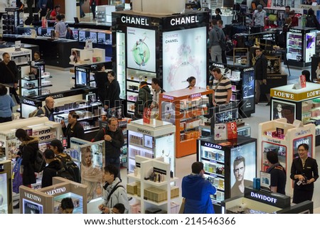 DOHA, QATAR - FEBRUARY 18, 2014: Tourists shopping at Duty Free Shop at Doha International Airport, the only commercial airport in Qatar.