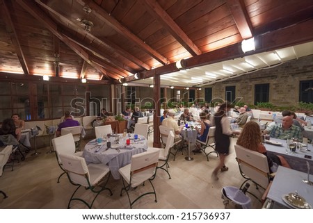 DUBROVNIK, CROATIA - MAY 27, 2014: Guests and waitress in Proto restaurant, one of Dubrovnik\'s best known places for fish specialities.