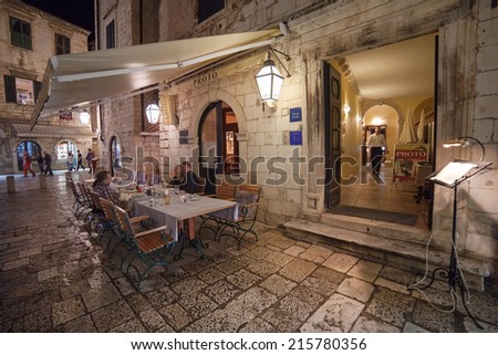 DUBROVNIK, CROATIA - MAY 27, 2014: People sitting at the table at restaurant Proto\'s  terrace. Dubrovnik has many restaurants which offer traditional Dalmatian cuisine and some great wine lists.