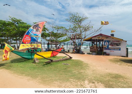 WELIGAMA, SRI LANKA - MARCH 7, 2014: Catamaran, sea food restaurant on the beach. These outlets serve mainly tourists and surfers, working all day and night.