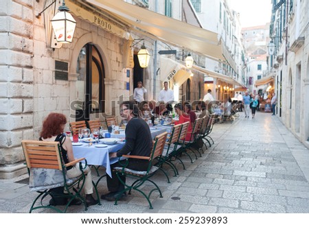 DUBROVNIK, CROATIA - MAY 28, 2014: Guests sitting at Proto restaurant terrace, one of Dubrovnik\'s best known places for fish specialities.