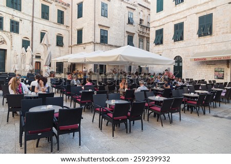 DUBROVNIK, CROATIA - MAY 28, 2014: Guests sitting at restaurant terrace. Dubrovnik has many restaurants which offer traditional Dalmatian cuisine and some great wine lists.
