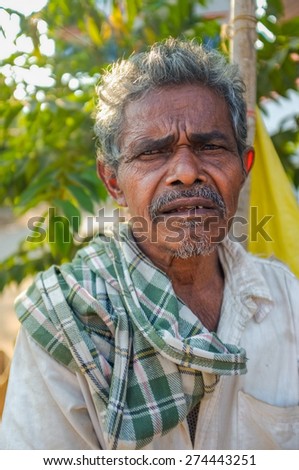 HAMPI, INDIA - 31 JANUARY 2015: Indian elderly man with checked scarf